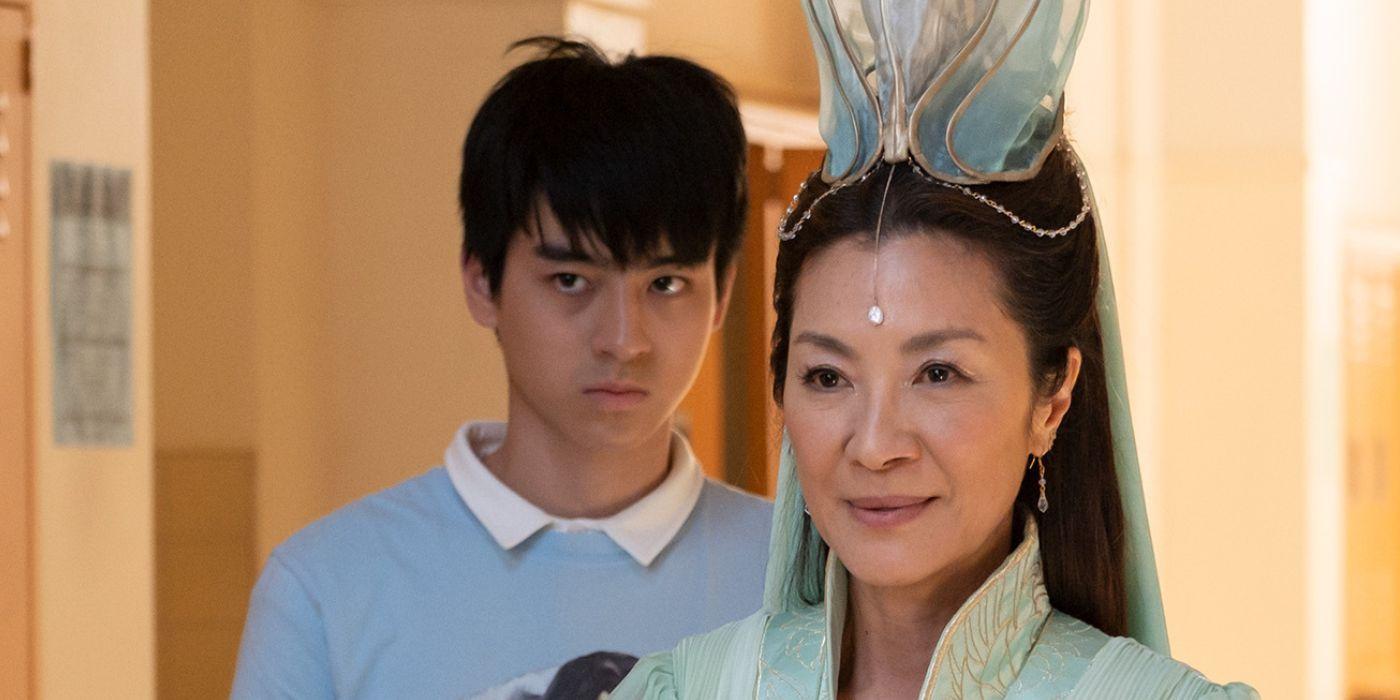 Ben Wang as Jin Wang and Michelle Yeoh as Guanyin in a school hallway American Born Chinese