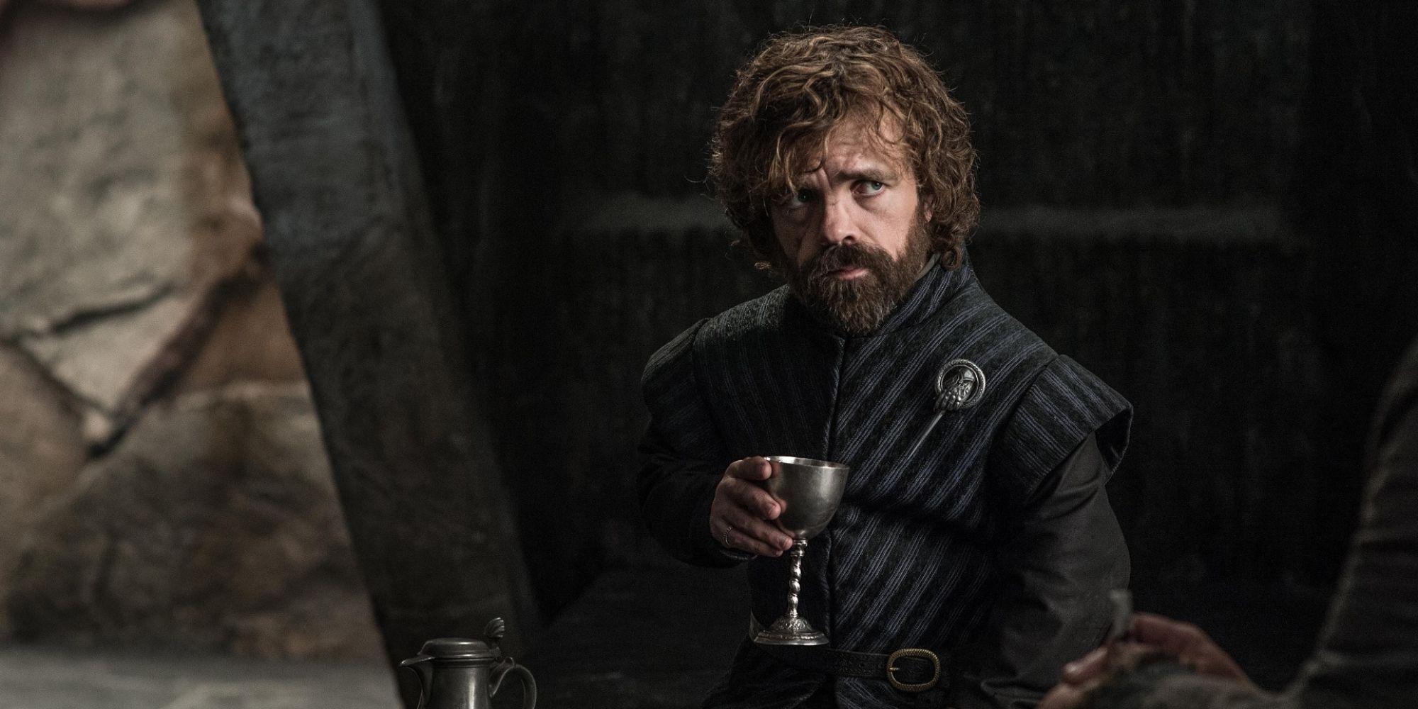 Peter Dinklage as Tyrion Lannister sitting down and drinkin from a goblet in Game of Thrones.