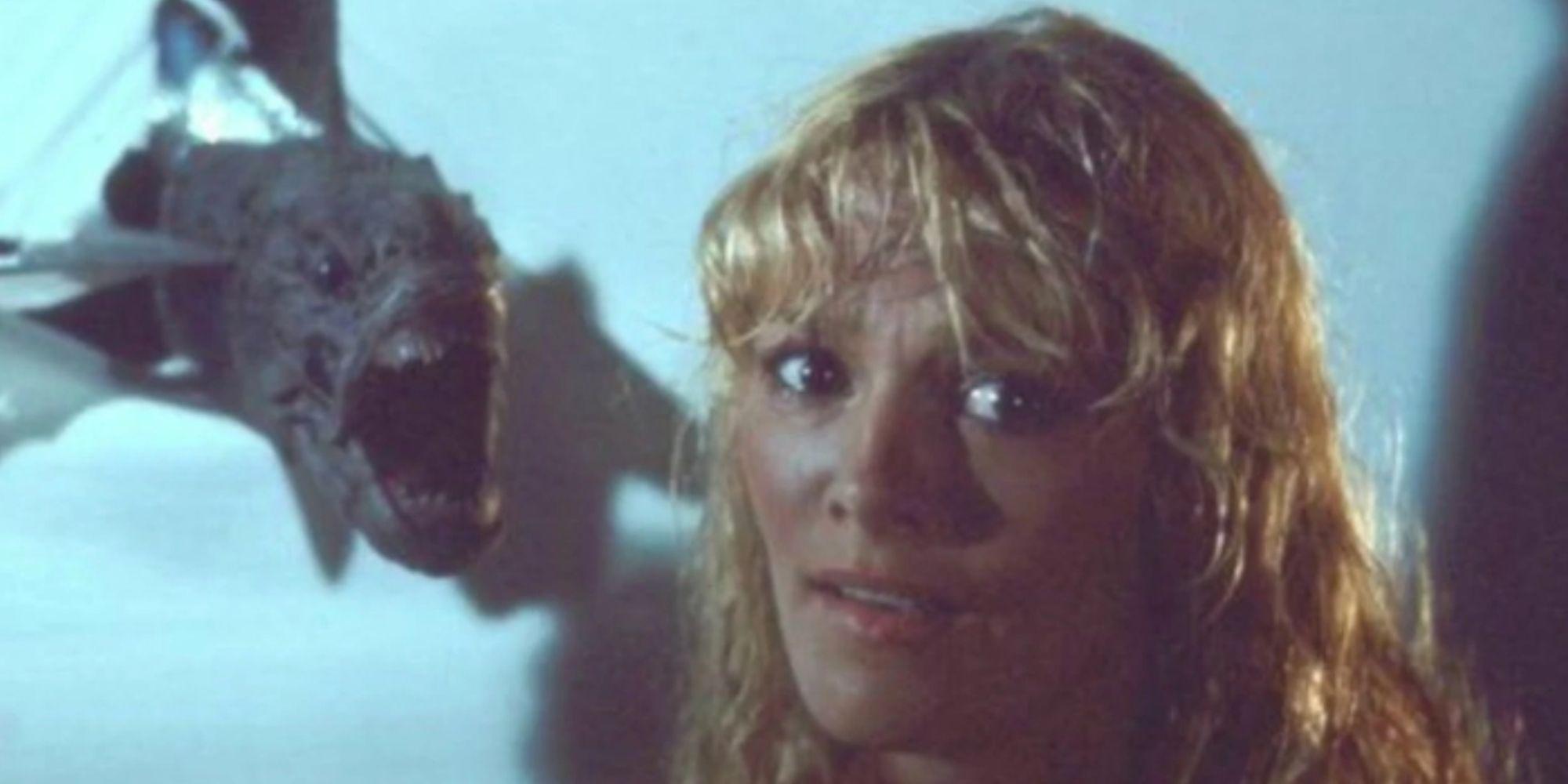 Connie Lynn Hadden as Loretta with a piranha flying toward her head with its mouth wide open in Piranha II: The Spawning